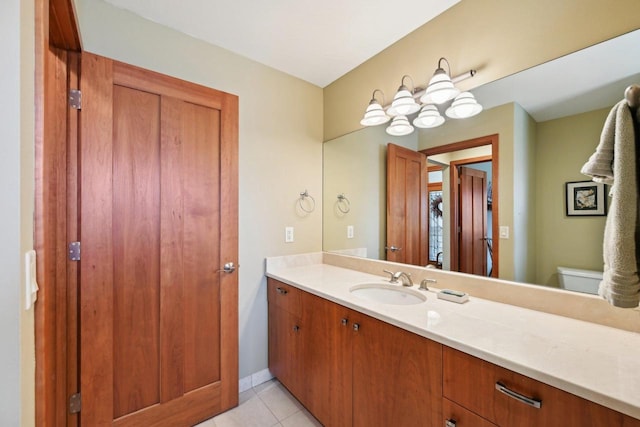 bathroom with tile patterned floors, toilet, baseboards, and vanity