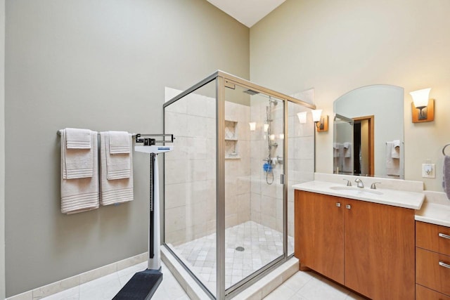 bathroom featuring a shower stall, tile patterned flooring, and vanity