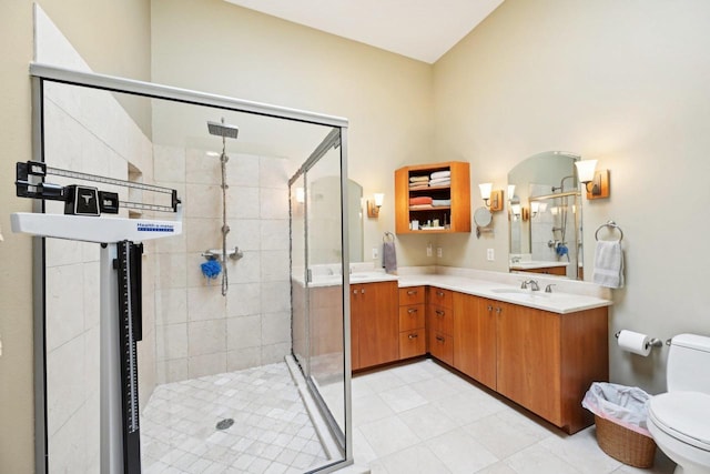 full bathroom with a stall shower, toilet, and vanity