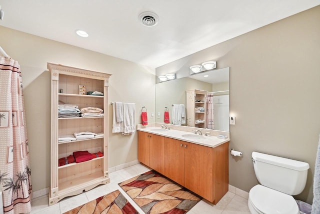 full bathroom featuring toilet, a sink, tile patterned flooring, visible vents, and double vanity