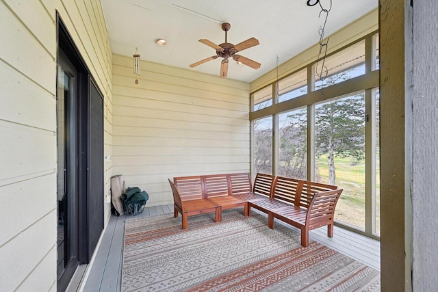 sunroom featuring a ceiling fan