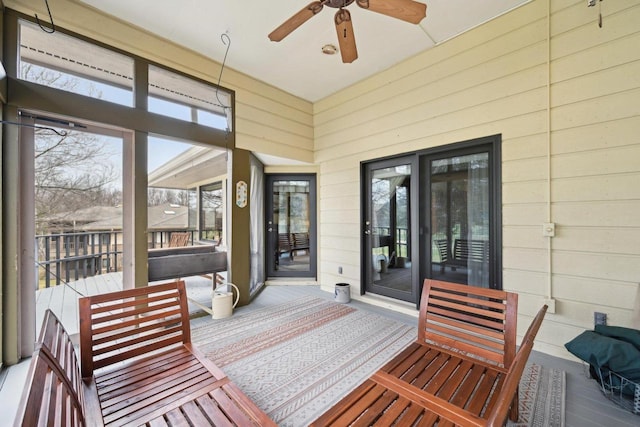 sunroom with a ceiling fan and a healthy amount of sunlight
