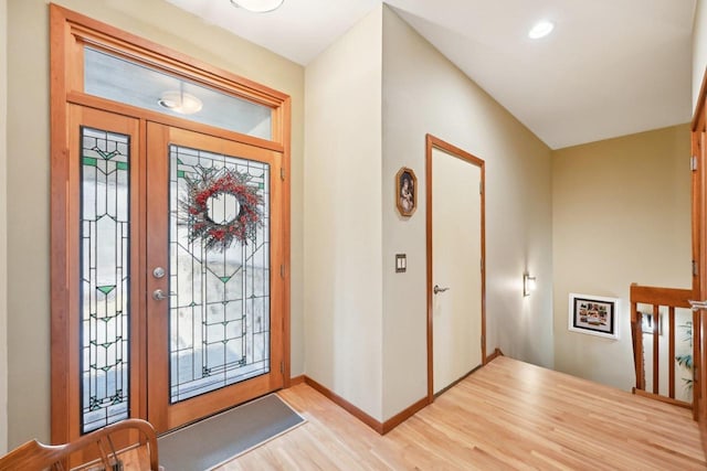 foyer with baseboards, recessed lighting, and light wood-type flooring
