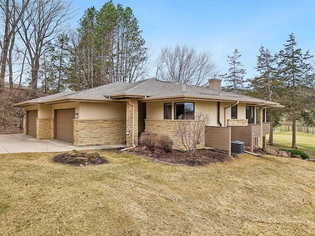 view of front facade with stucco siding, driveway, a front lawn, a garage, and a chimney