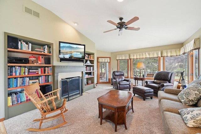 carpeted living area with a ceiling fan, a fireplace with flush hearth, lofted ceiling, and visible vents