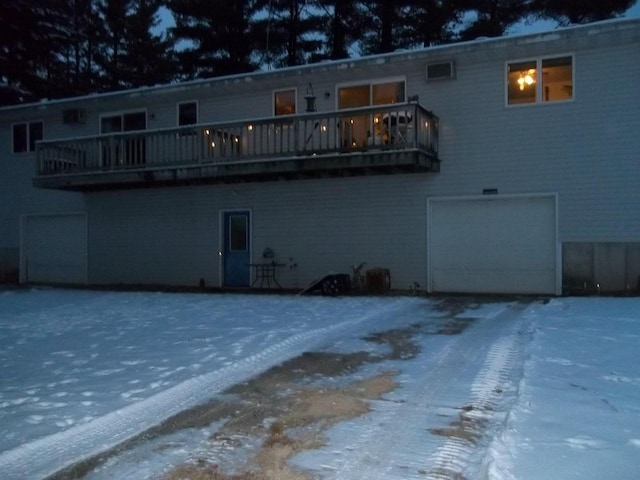 rear view of property featuring a garage