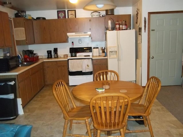 kitchen with light countertops, under cabinet range hood, and black appliances