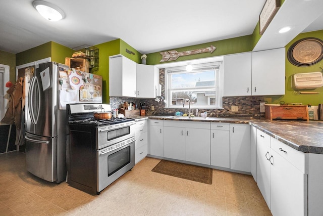505 S Main St, Edgerton, WI 53534 - kitchen featuring decorative backsplash, a sink, dark countertops, and double oven range