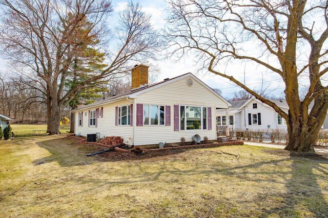 505 S Main St, Edgerton, WI 53534 - ranch-style house with a chimney, central air condition unit, and a front yard
