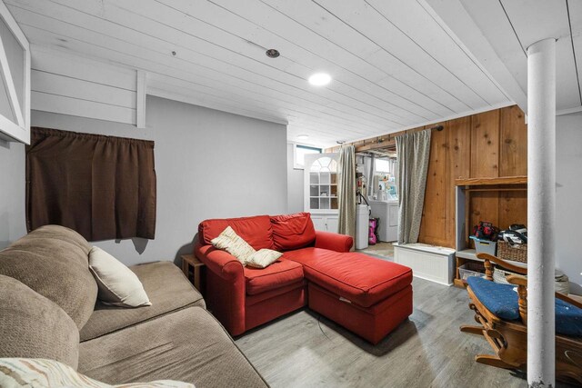 505 S Main St, Edgerton, WI 53534 - living room featuring wood ceiling, wood finished floors, washer / dryer, and wood walls