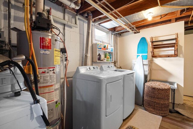505 S Main St, Edgerton, WI 53534 - laundry room featuring washing machine and clothes dryer, gas water heater, laundry area, and wood finished floors