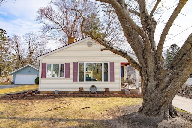505 S Main St, Edgerton, WI 53534 - view of front of house featuring a front lawn, a chimney, and an outbuilding
