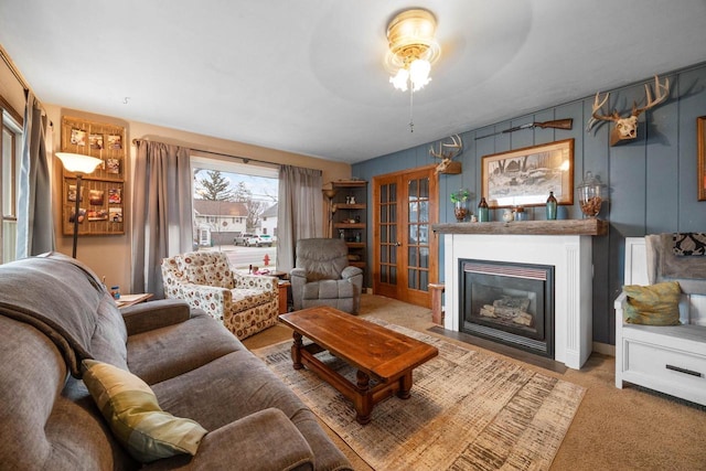 505 S Main St, Edgerton, WI 53534 - carpeted living area featuring a fireplace with flush hearth, ceiling fan, and french doors