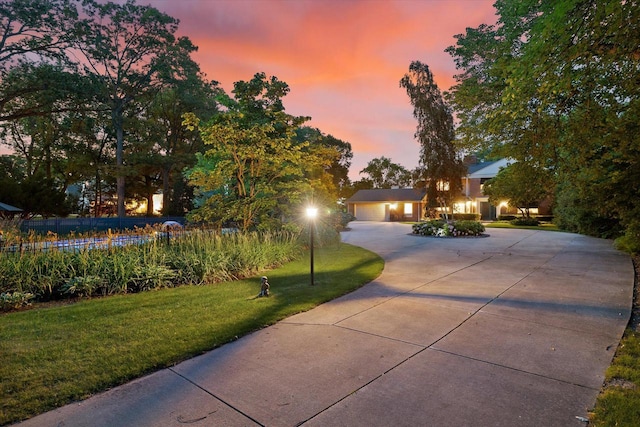 4696 N Lake Dr, Whitefish Bay, WI 53211 - view of front of home featuring curved driveway, fence, and a front lawn