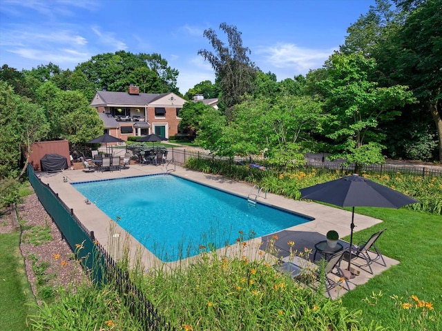 4696 N Lake Dr, Whitefish Bay, WI 53211 - community pool featuring a patio area, fence, and a lawn