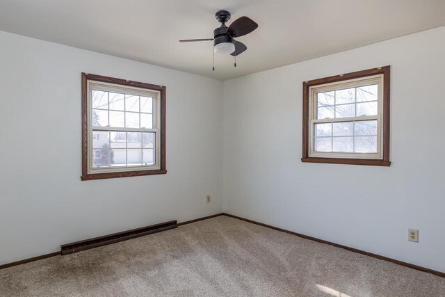 unfurnished room featuring baseboards, carpet flooring, ceiling fan, and a baseboard radiator