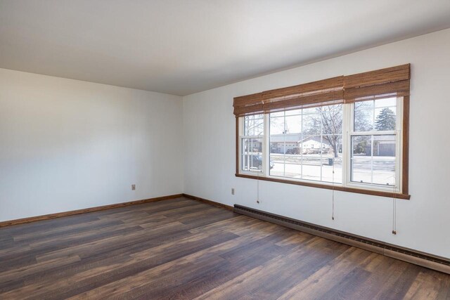 unfurnished room featuring a baseboard radiator, dark wood-type flooring, and baseboards
