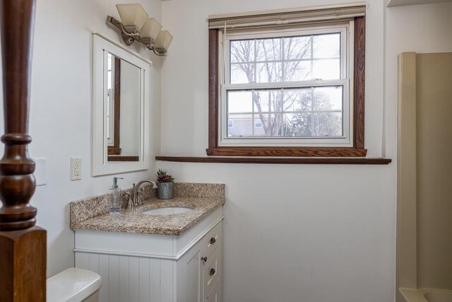 bathroom featuring toilet and vanity