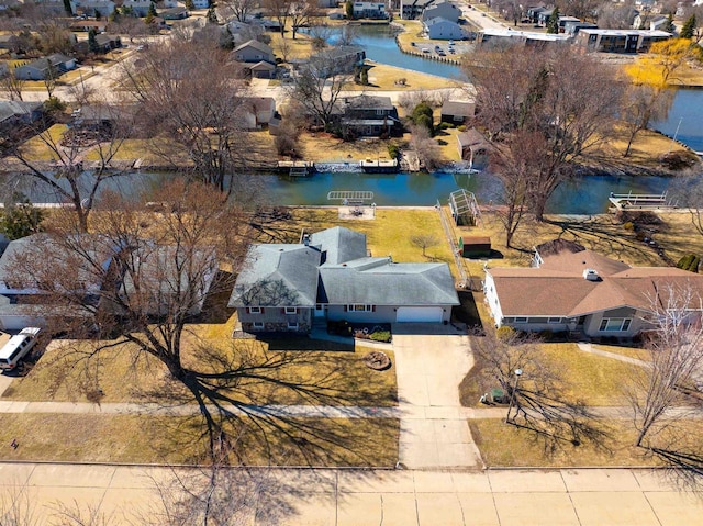 drone / aerial view with a residential view and a water view