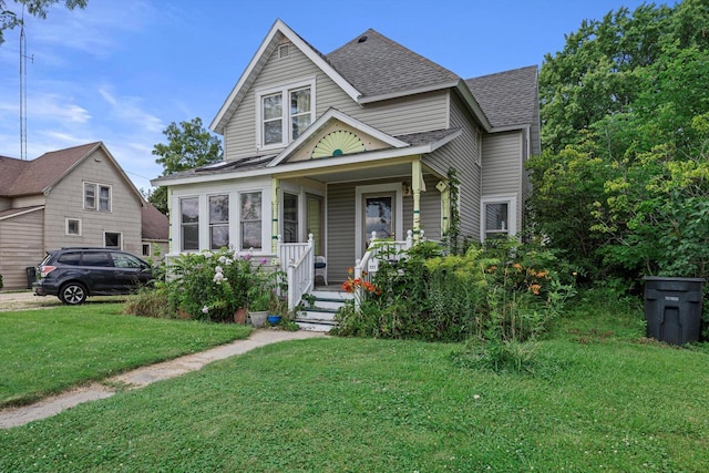 721 N St, Lake Geneva, WI 53147 - view of front of property with a porch, a shingled roof, and a front lawn