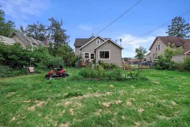 721 N St, Lake Geneva, WI 53147 - rear view of property with a yard and a vegetable garden