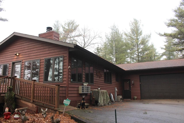 1885 20th Ave, Arkdale, WI 54613 - view of property exterior with driveway, an attached garage, and a chimney