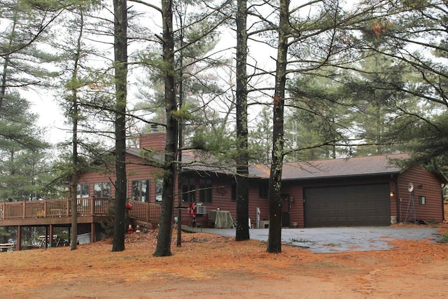 1885 20th Ave, Arkdale, WI 54613 - view of front of property featuring a chimney, an attached garage, a wooden deck, and driveway