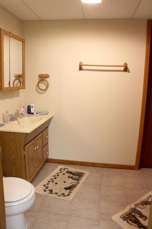 1885 20th Ave, Arkdale, WI 54613 - bathroom featuring a drop ceiling, vanity, tile patterned floors, toilet, and baseboards