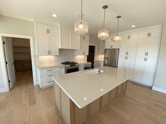 901 Westbridge Ct, Waunakee, WI 53597 - kitchen featuring appliances with stainless steel finishes, a sink, recessed lighting, light wood-type flooring, and white cabinets