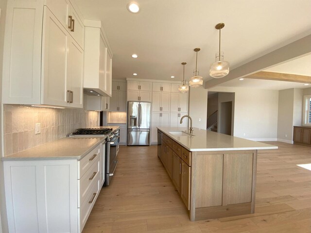 901 Westbridge Ct, Waunakee, WI 53597 - kitchen with stainless steel appliances, a sink, recessed lighting, backsplash, and light wood-type flooring