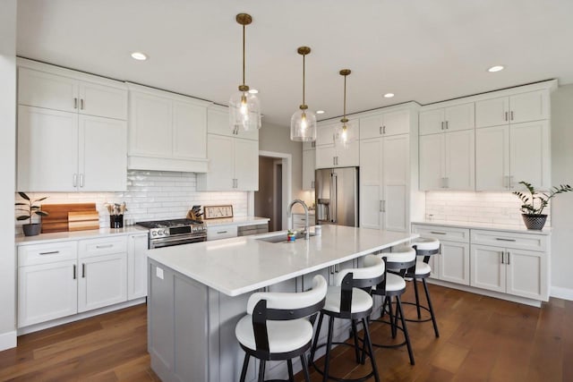 901 Westbridge Ct, Waunakee, WI 53597 - kitchen with stainless steel appliances, a sink, tasteful backsplash, white cabinets, and light countertops
