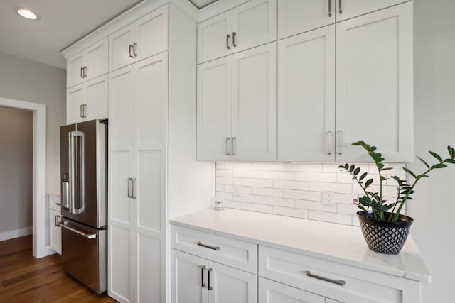 901 Westbridge Ct, Waunakee, WI 53597 - kitchen featuring high quality fridge, white cabinets, baseboards, backsplash, and light stone counters
