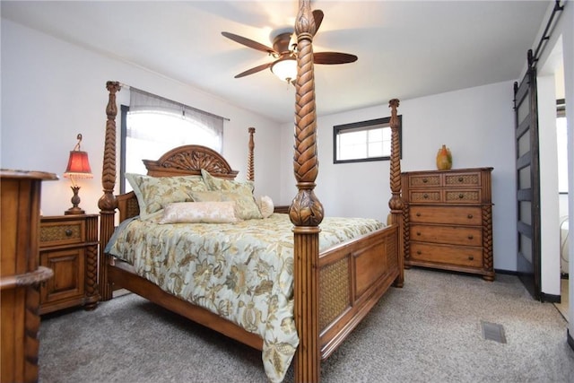 8160 Waldora Rd, Siren, WI 54872 - bedroom featuring light colored carpet, visible vents, a barn door, and ceiling fan