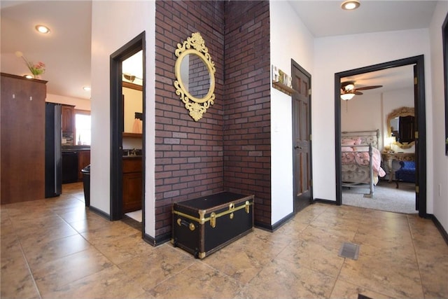8160 Waldora Rd, Siren, WI 54872 - corridor featuring baseboards, recessed lighting, and brick wall