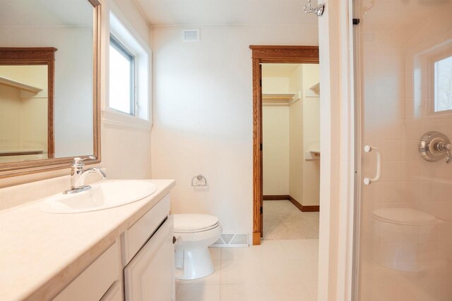 full bath with a stall shower, toilet, visible vents, tile patterned flooring, and vanity