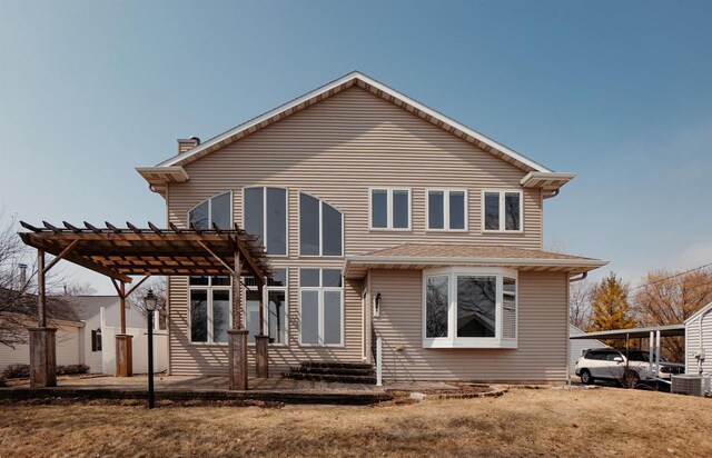 back of property featuring a chimney, central AC unit, and a pergola