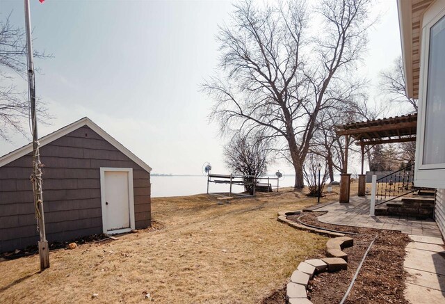 view of yard featuring an outbuilding and a storage shed