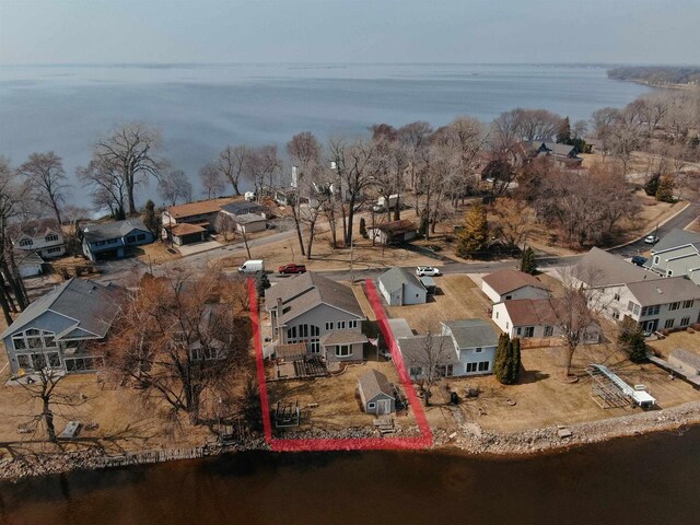 birds eye view of property with a water view and a residential view