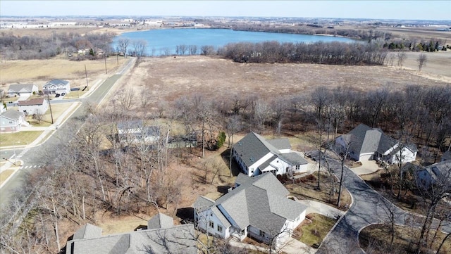 drone / aerial view featuring a residential view and a water view