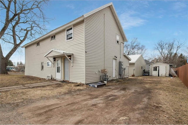 905 Lewis Ave, Cameron, WI 54822 - back of house featuring an outdoor structure, a shed, and fence