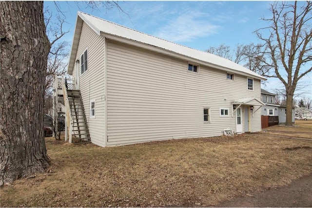905 Lewis Ave, Cameron, WI 54822 - back of house featuring stairs, metal roof, and a lawn