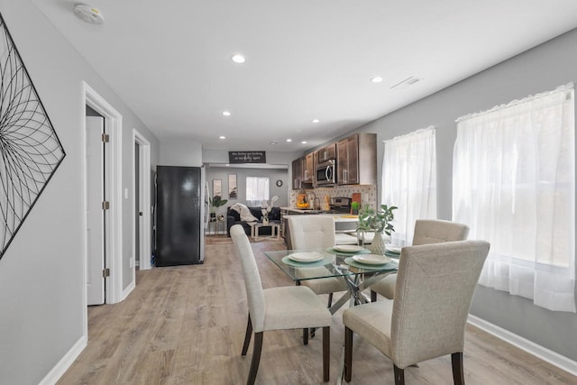 33110 Store St, Burlington, WI 53105 - dining area with plenty of natural light, baseboards, visible vents, and light wood-style floors