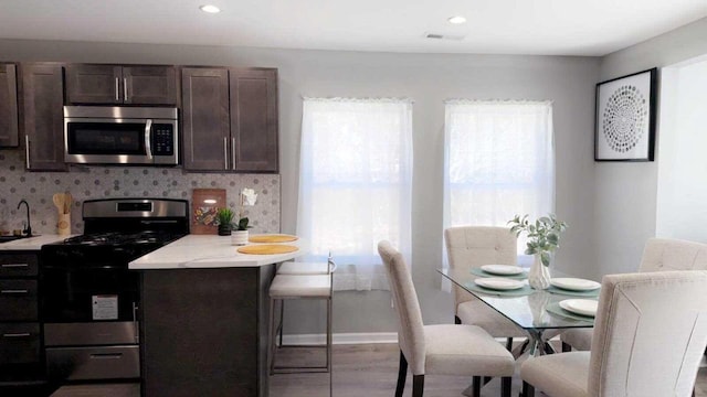 33110 Store St, Burlington, WI 53105 - kitchen with light countertops, dark brown cabinetry, appliances with stainless steel finishes, and tasteful backsplash