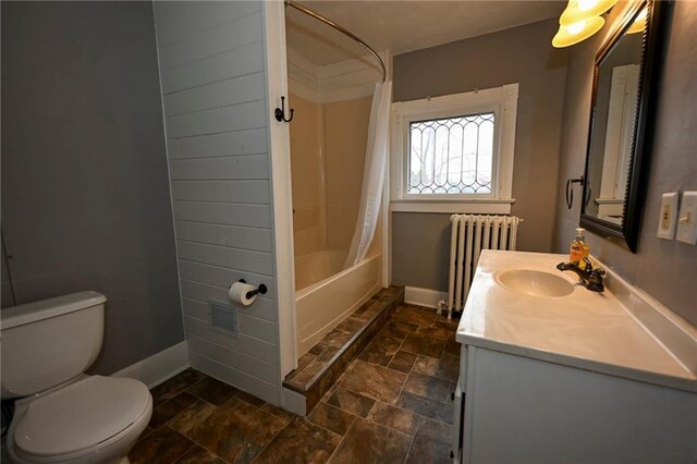 301 Summit St, Spooner, WI 54801 - full bath with toilet, stone finish flooring, vanity, radiator heating unit, and baseboards