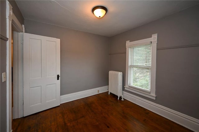 301 Summit St, Spooner, WI 54801 - spare room with radiator heating unit, baseboards, and wood finished floors