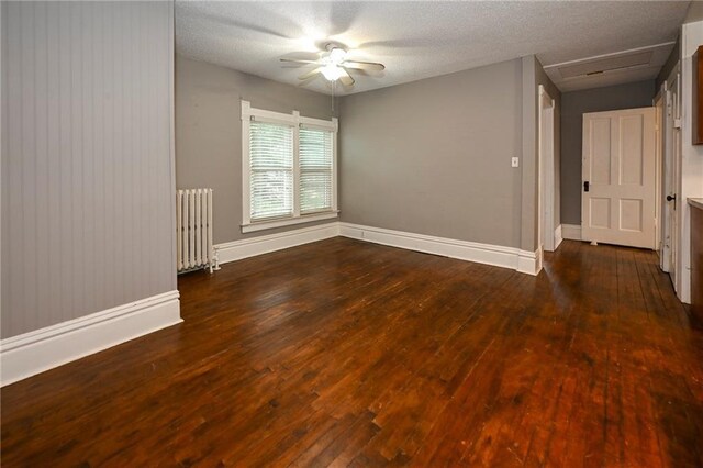 301 Summit St, Spooner, WI 54801 - unfurnished room with hardwood / wood-style flooring, attic access, radiator, baseboards, and ceiling fan