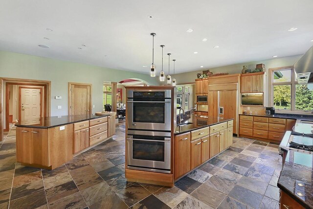 7548 Fallen Oak Dr, Verona, WI 53593 - kitchen featuring built in appliances, a spacious island, recessed lighting, and stone tile floors