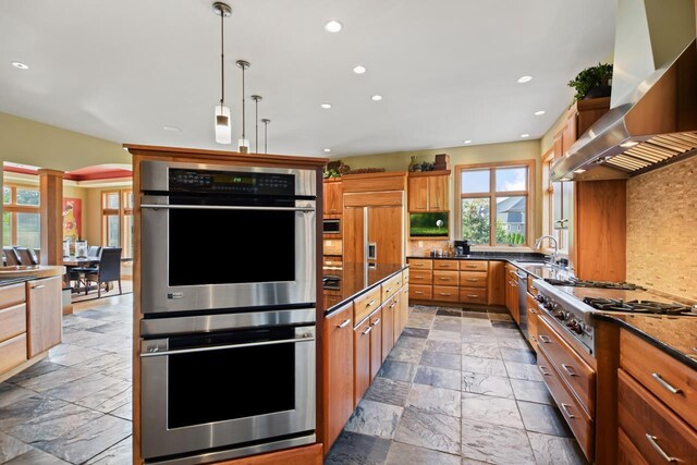 7548 Fallen Oak Dr, Verona, WI 53593 - kitchen with a sink, stone tile flooring, stainless steel appliances, and wall chimney exhaust hood