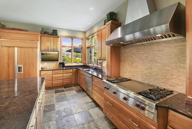 7548 Fallen Oak Dr, Verona, WI 53593 - kitchen with stone tile floors, a sink, wall chimney exhaust hood, tasteful backsplash, and appliances with stainless steel finishes