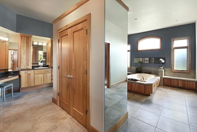 7548 Fallen Oak Dr, Verona, WI 53593 - bathroom with tile patterned floors, vanity, a bath, and baseboards